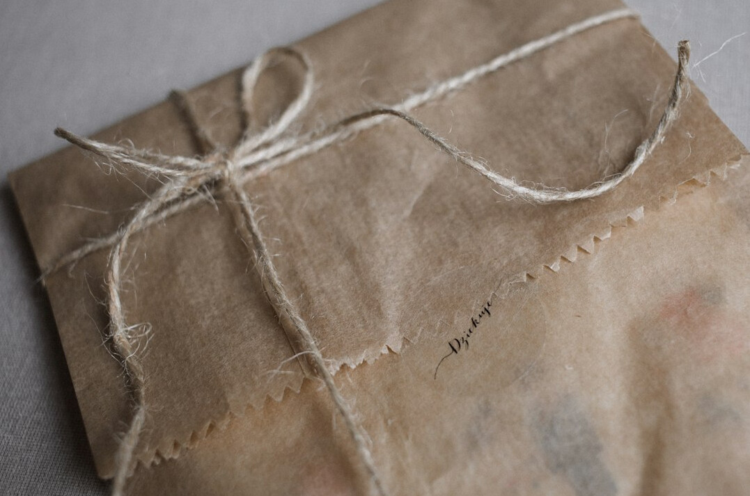 Parcel with mystery paperbacks tied with twine on a table