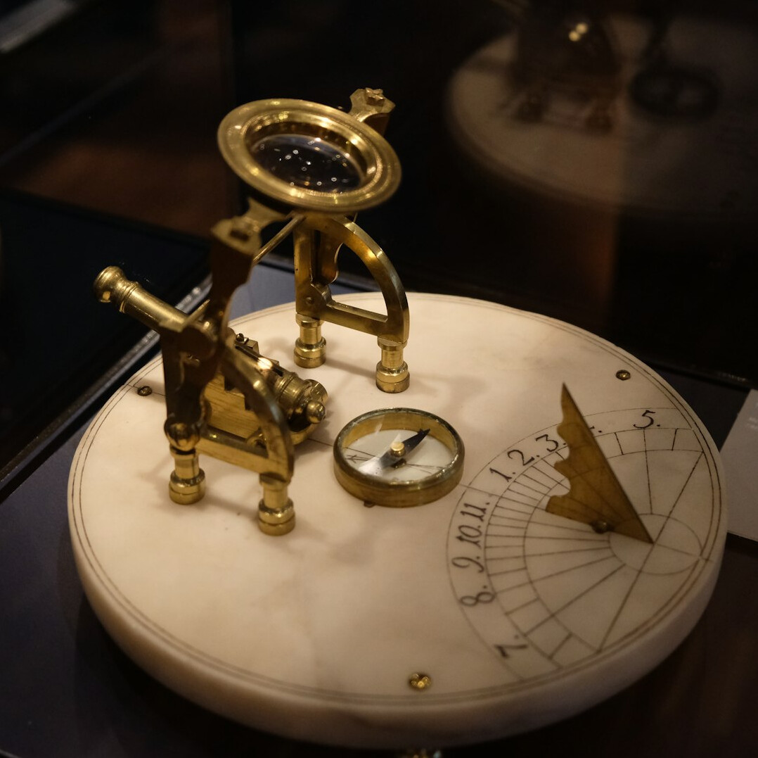 Old map with a magnifying glass and brass compass
